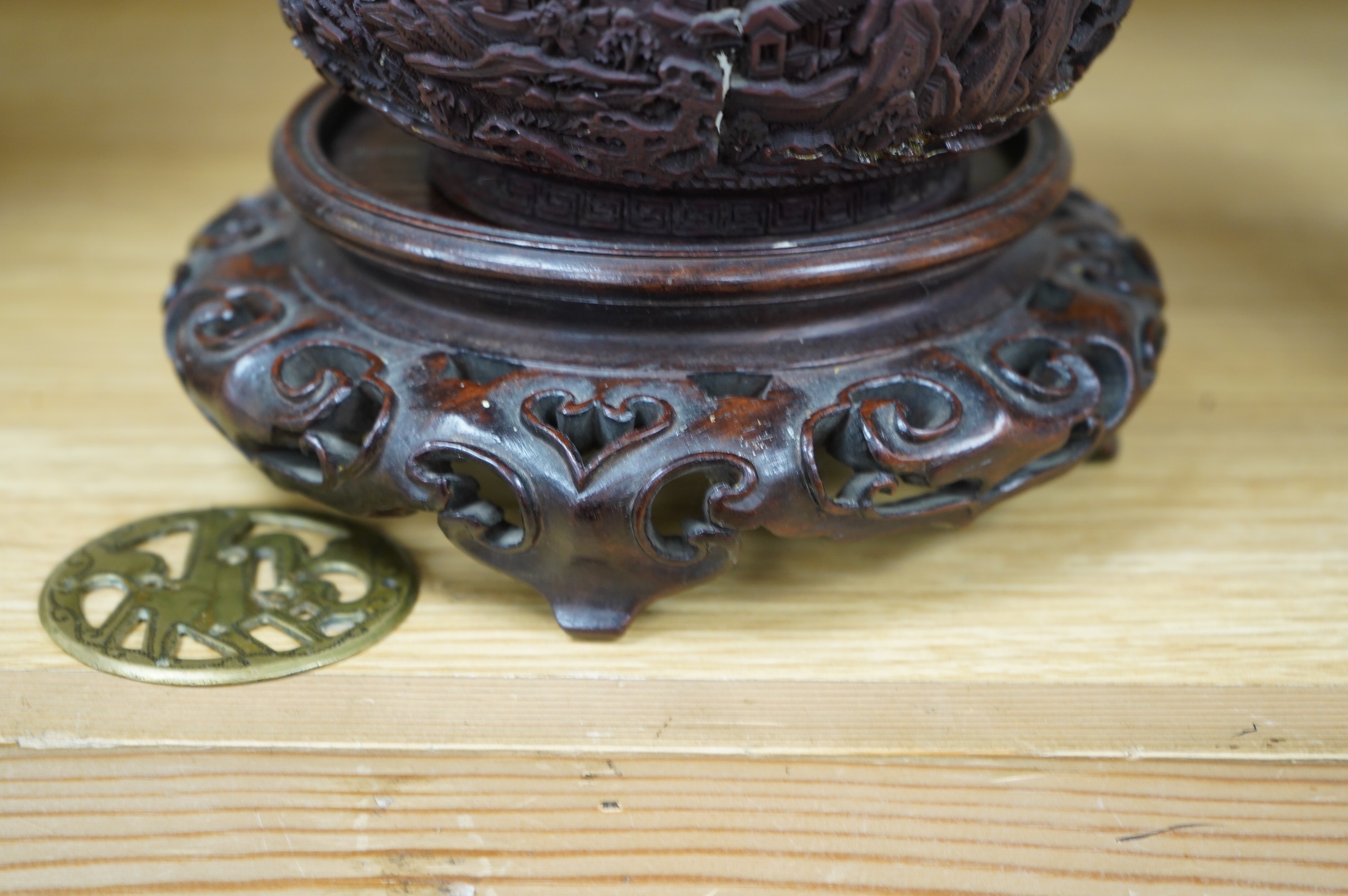 An 18th/19th century Chinese cinnabar lacquer bowl, on carved hongmu stand and a Chinese pierced brass disc. Condition - poor